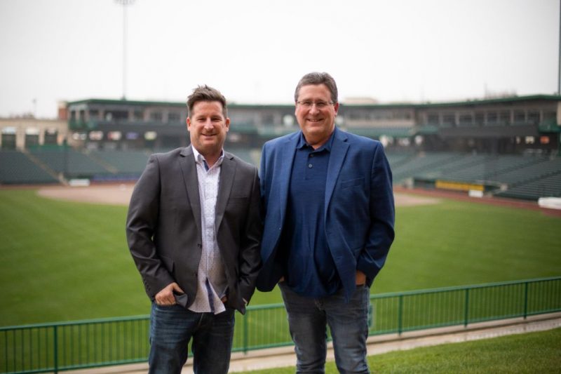 Rich And Dan Standing At A Ball Park