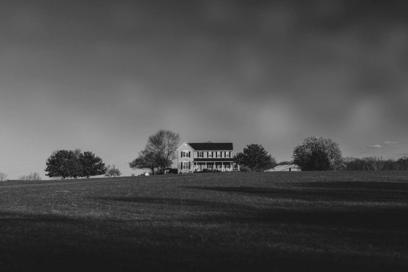 Home 3 Solitary house in a vast open field under a cloudy sky in Charlottesville, Virginia.